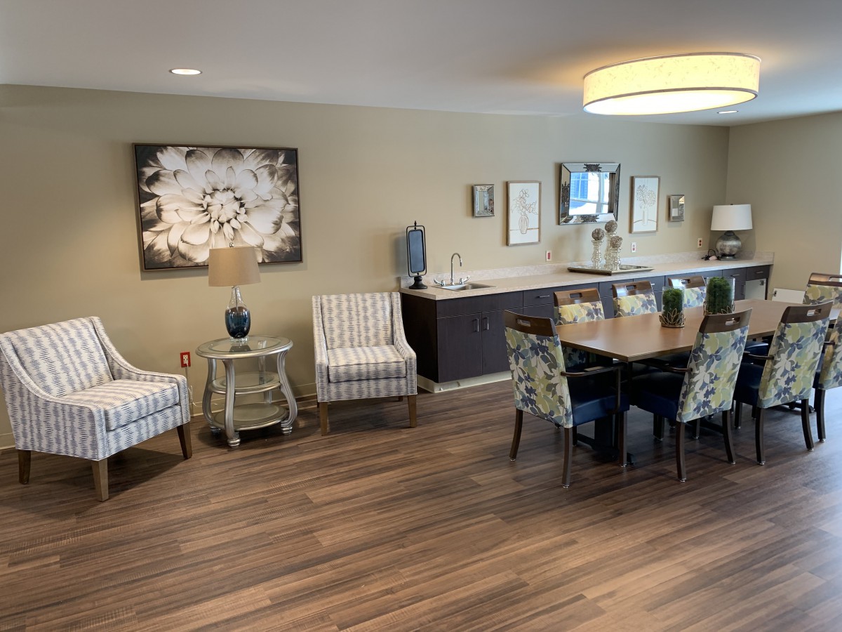 A modern dining room with wood flooring and stylish decor.