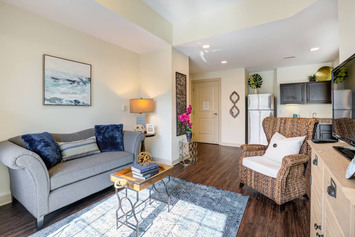 A cozy living room featuring a sofa, chair, coffee table, and stylish decor.
