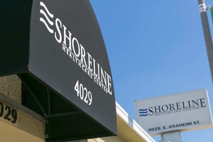 The storefront of Shoreline, featuring a prominent black awning with the business name and address number 4029.
