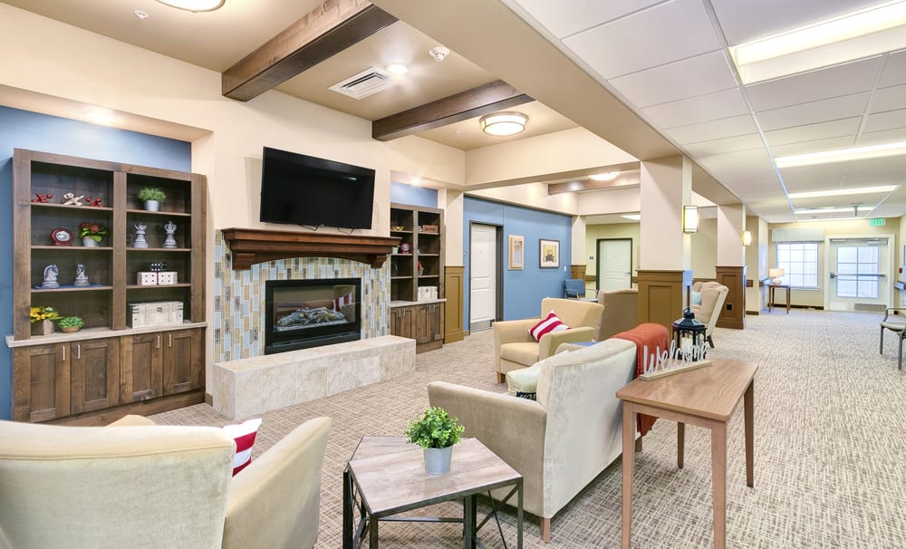 A modern living room with comfortable seating, a fireplace, and a television.