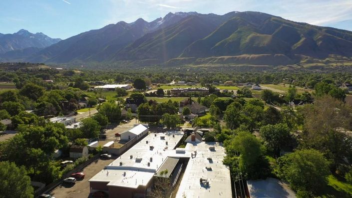A scenic view of a rural area with mountains in the background.
