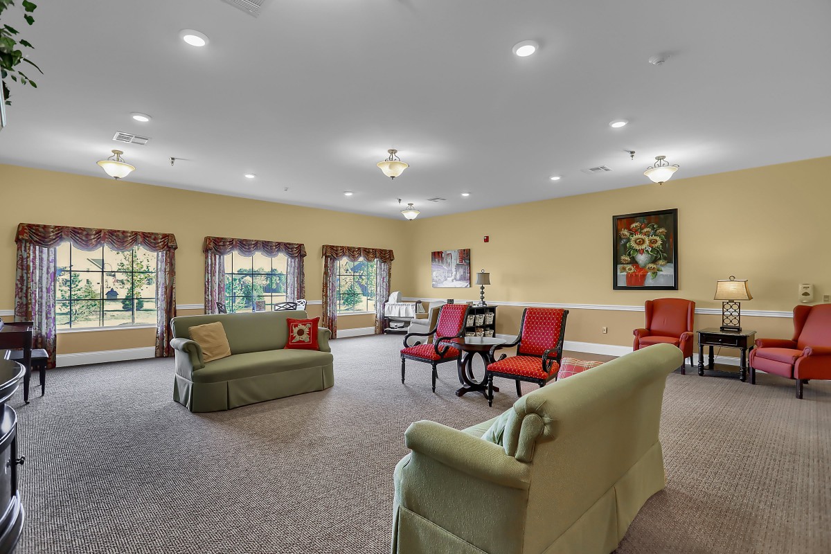 A spacious living room with comfortable seating and elegant decor.