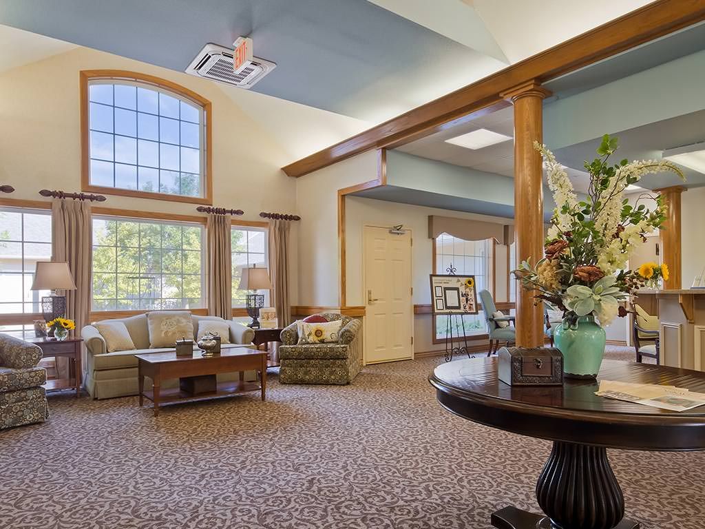 A cozy lobby area with comfortable seating and large windows letting in natural light.