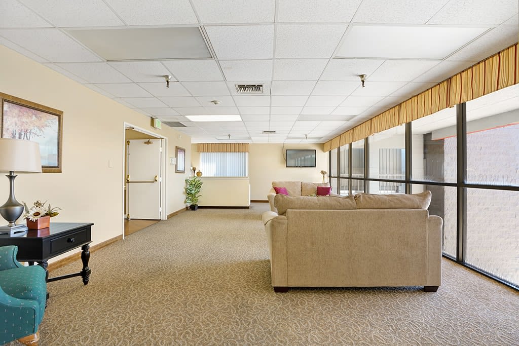 A spacious lobby with comfortable seating and large windows.