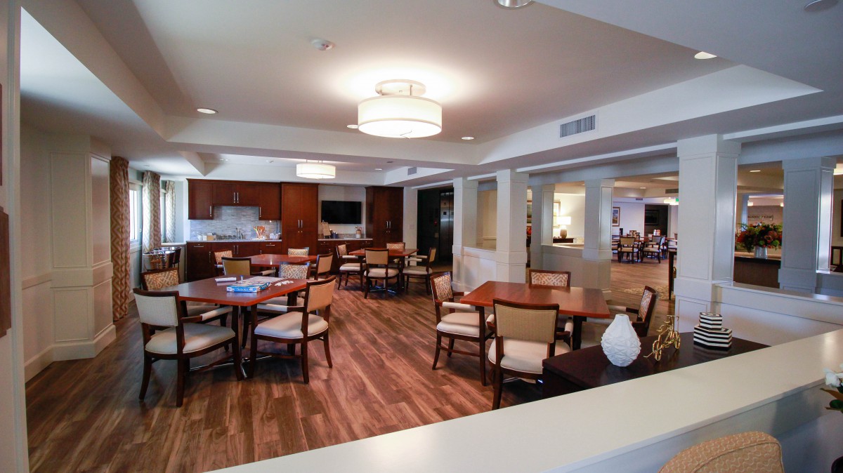 A modern dining area with wooden floors and contemporary furniture.
