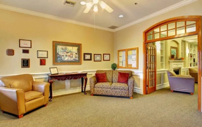 A cozy lobby area with comfortable seating and artwork on the walls.