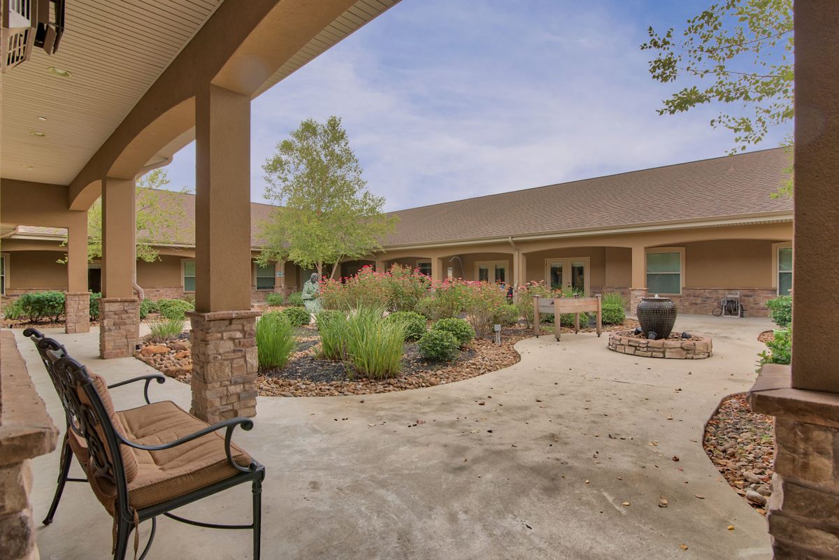 A peaceful courtyard with well-maintained landscaping and seating areas.