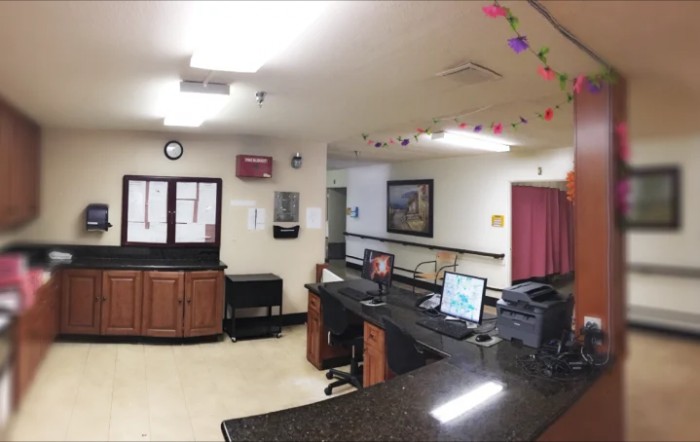 A reception area with desks, computers, and colorful ceiling decorations.