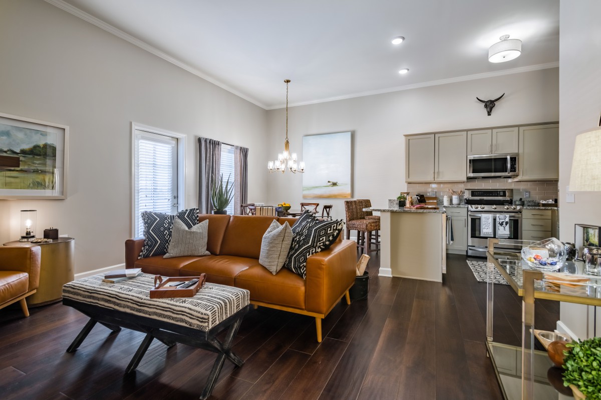A modern open-concept living room and kitchen with a cozy ambiance.