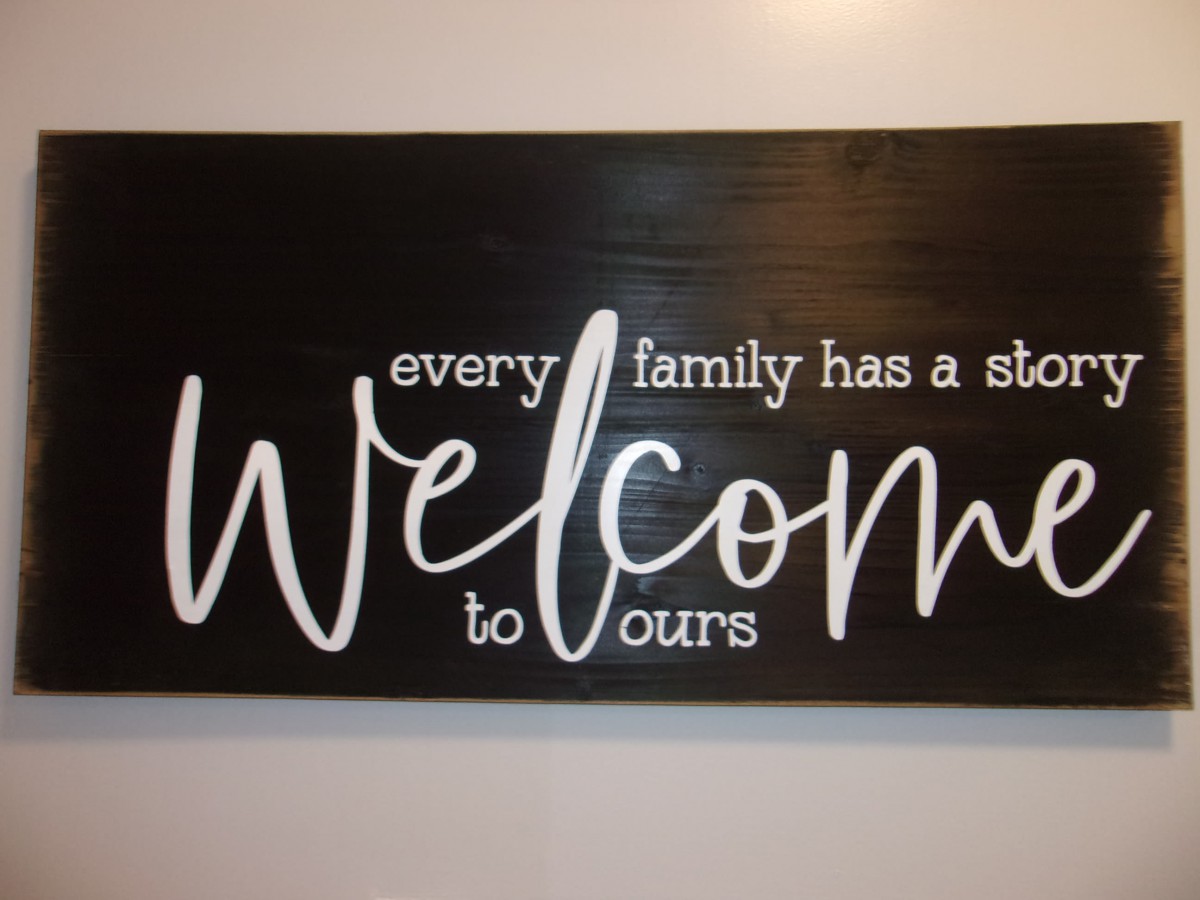 A welcoming wall sign with a family-themed message.