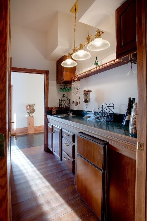 A cozy kitchen with wooden cabinets and warm lighting.
