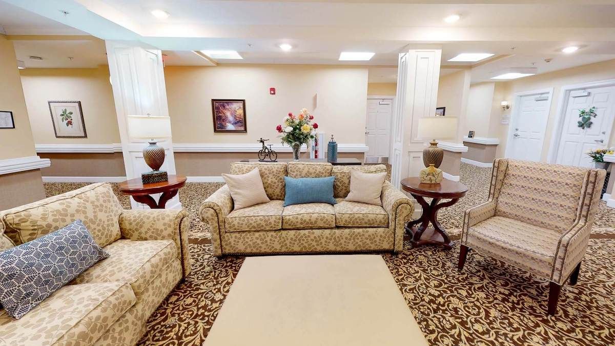 A well-decorated living room with patterned sofas, a rug, and various decorative elements.