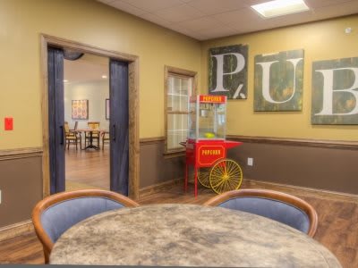 A cozy interior with a popcorn machine and seating area.