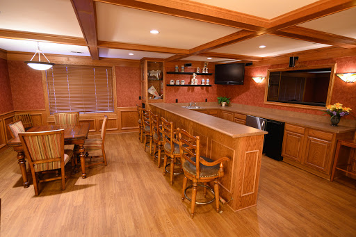 A cozy home bar featuring wooden furnishings and a welcoming atmosphere.