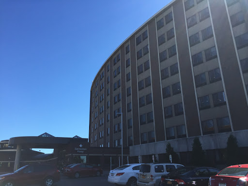 A modern hotel building under a clear blue sky.