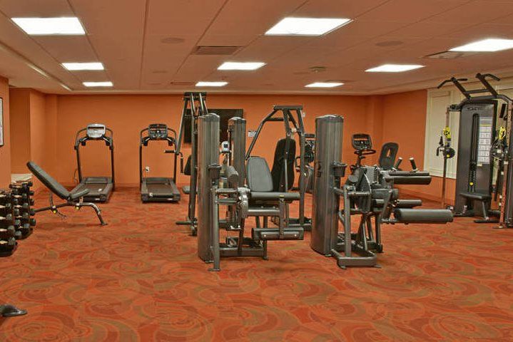 A spacious gym with various exercise equipment.