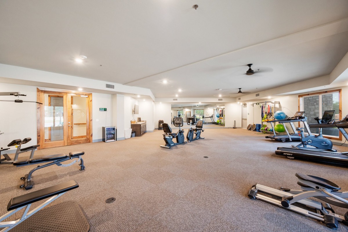 A spacious gym equipped with various exercise machines and fitness equipment.