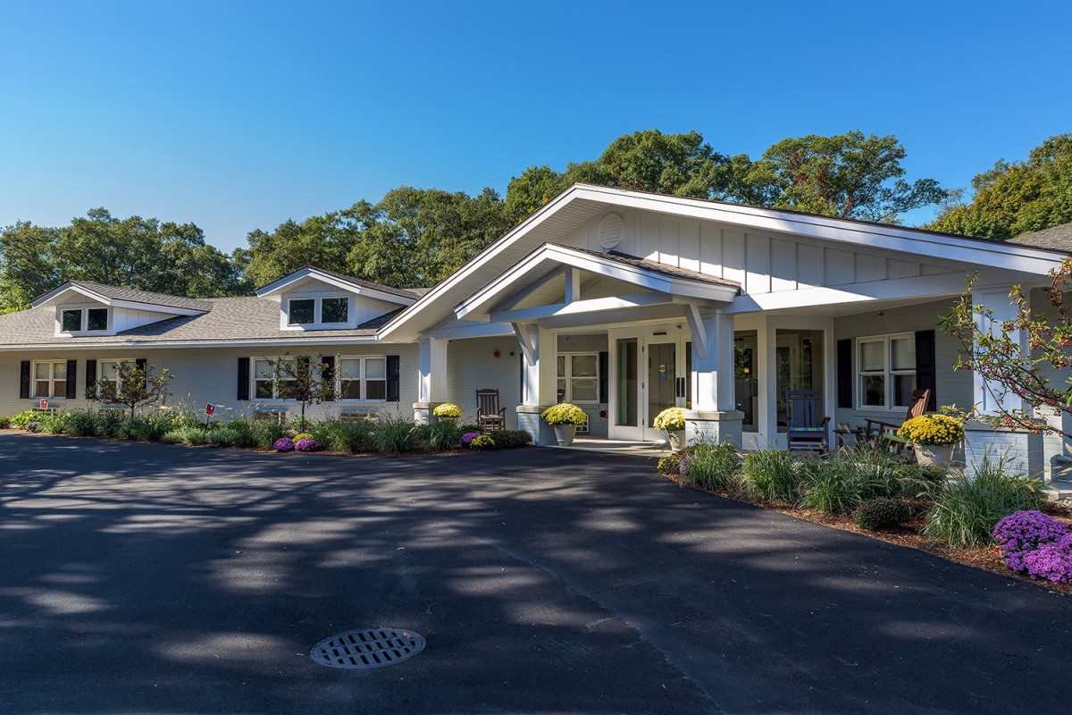 A residential house with a well-maintained front yard on a sunny day.