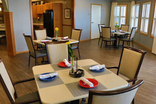 A cozy dining area set up for a meal, featuring decorated tables and a welcoming atmosphere.