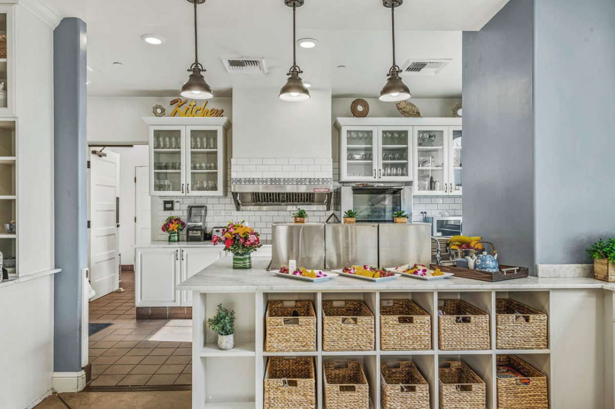 A modern kitchen with ample storage and elegant lighting.