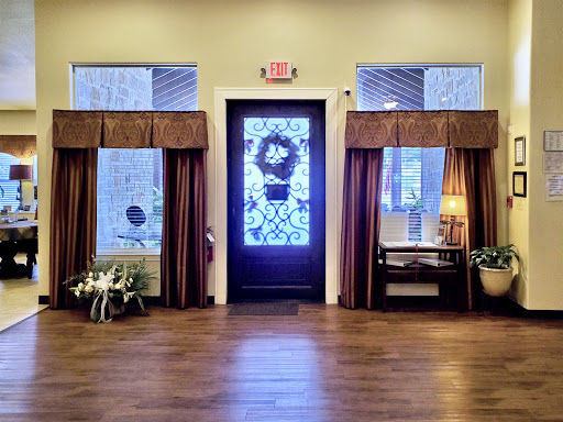 A welcoming entrance featuring a decorative door and elegant curtains.