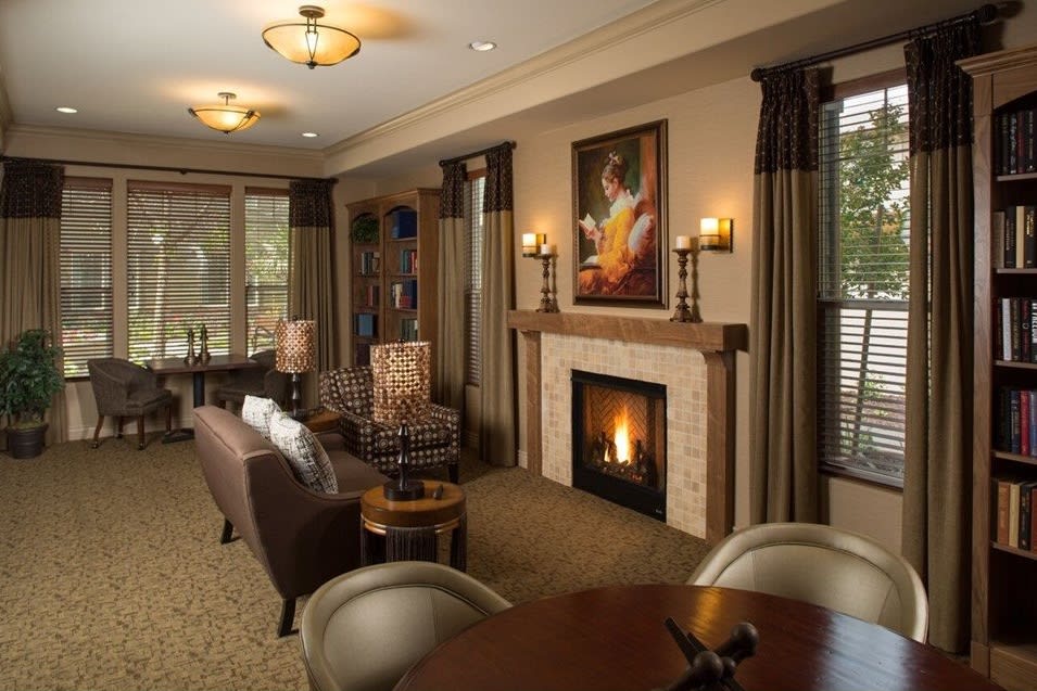 A cozy living room with a fireplace and comfortable seating.