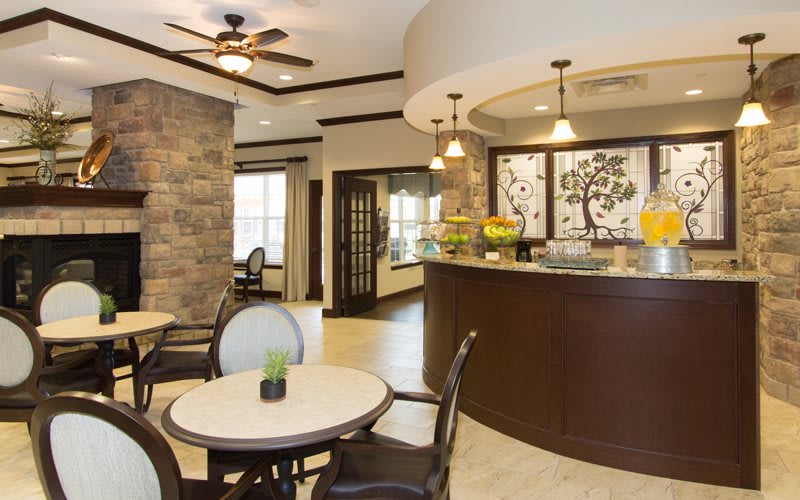 A modern lobby featuring a seating area and a reception desk with elegant decor.