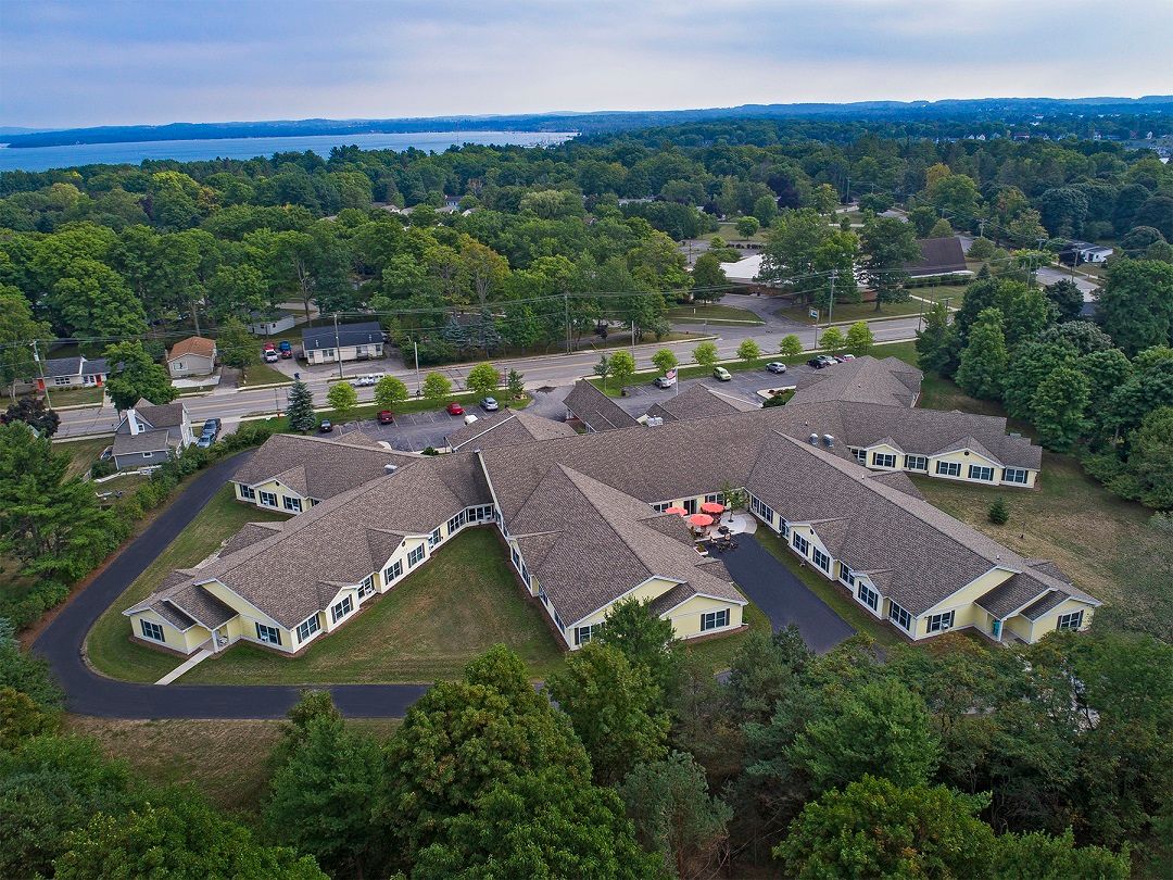 Aerial view of a residential building complex surrounded by trees.