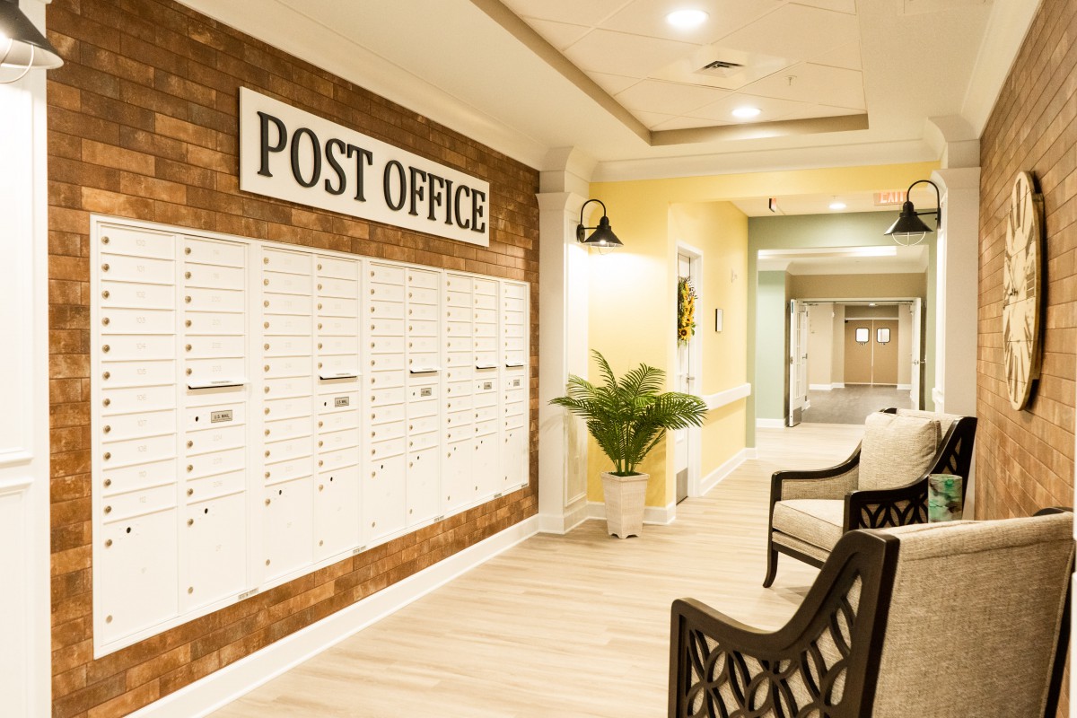 A post office interior with mailboxes and a seating area.