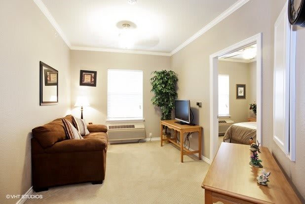 A cozy living room with a sofa, television, and decorative elements.