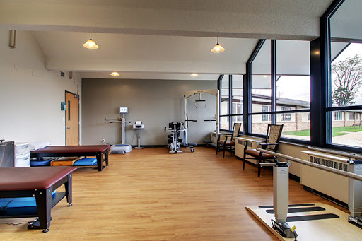 A bright and modern physical therapy room equipped with exercise tools and a welcoming atmosphere.