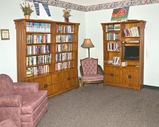 Cozy reading nook with wooden bookshelves and comfortable seating.