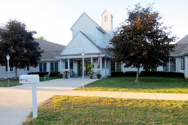 A charming church building surrounded by trees and greenery.