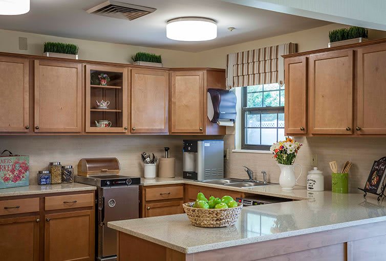 A cozy kitchen with wooden cabinets, a countertop island, and modern appliances.