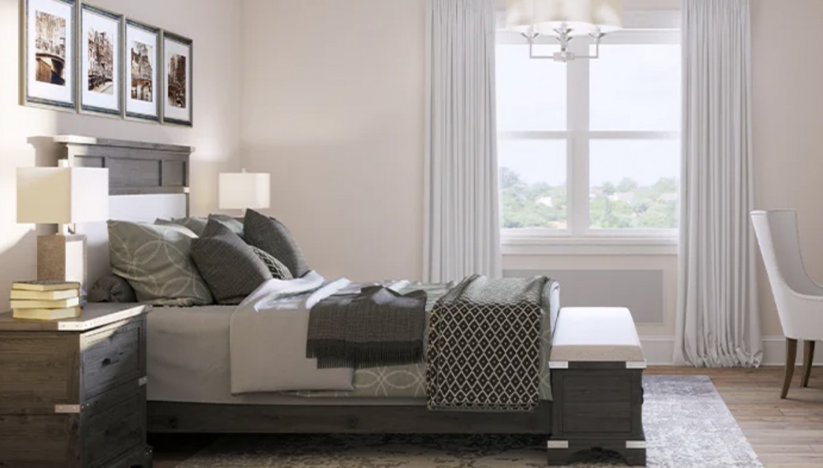 A modern bedroom with stylish decor and a large window.