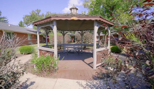 A beautifully designed gazebo in a serene garden setting.
