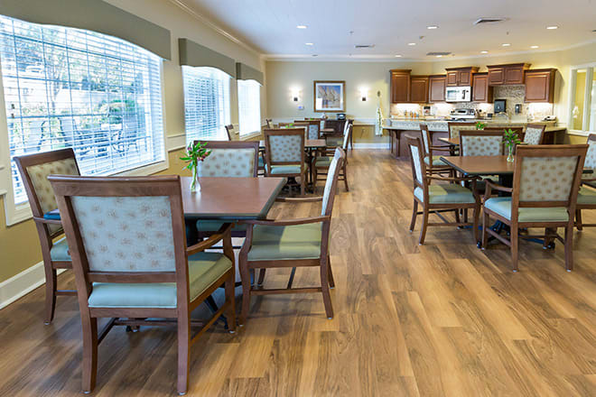 Bright and spacious dining area with wooden flooring and elegant furniture.