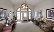 A spacious entryway with elegant decor and large windows.