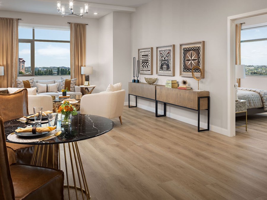 A modern living room and dining area with contemporary furnishings and neutral tones.