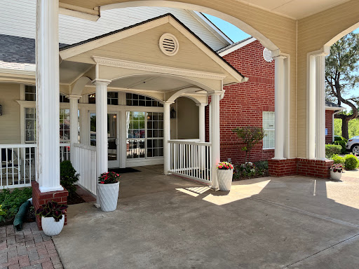 A welcoming entrance featuring elegant columns and a well-maintained outdoor area.