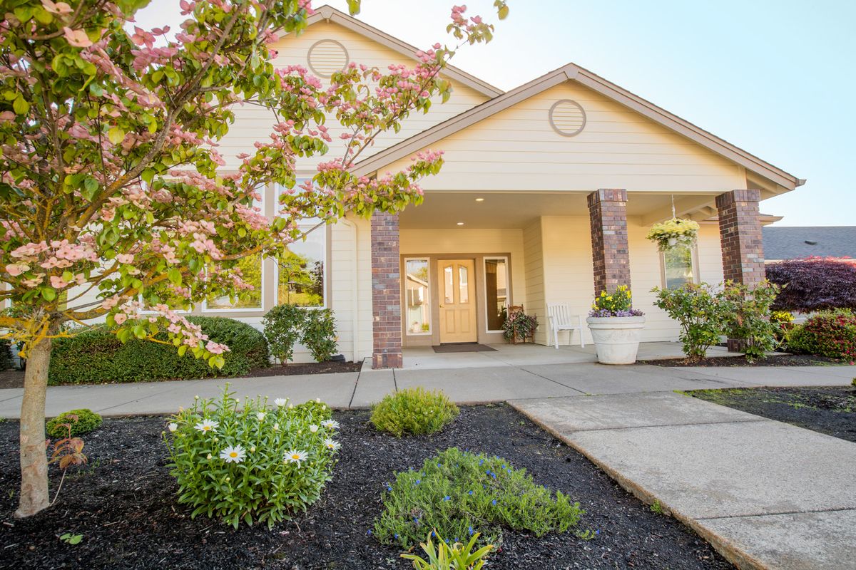 A well-maintained residential house with a landscaped garden and inviting entrance.