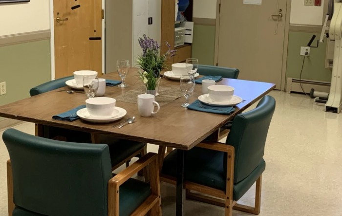 A neatly set dining table with dishes and cutlery, ready for a meal.