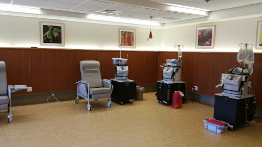 A treatment area in a healthcare facility equipped with infusion chairs and medical equipment.