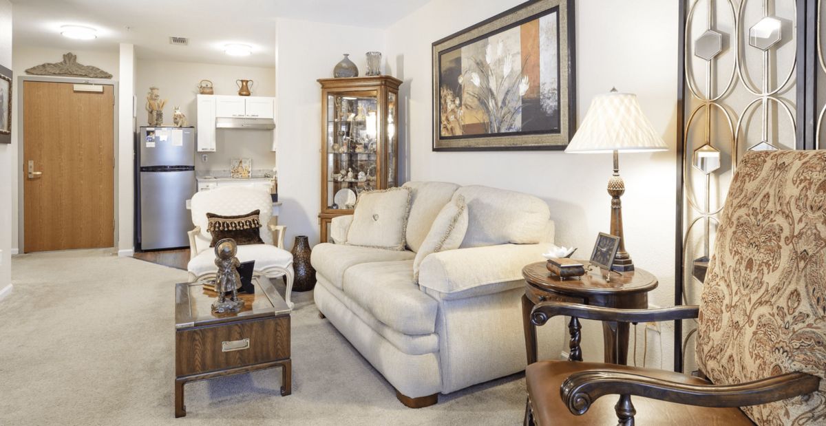 A cozy living room with a comfortable sofa, coffee table, and decorative items.