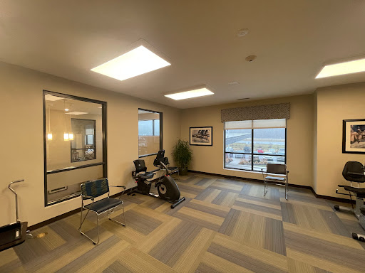 A spacious and modern waiting area with comfortable seating and large windows.