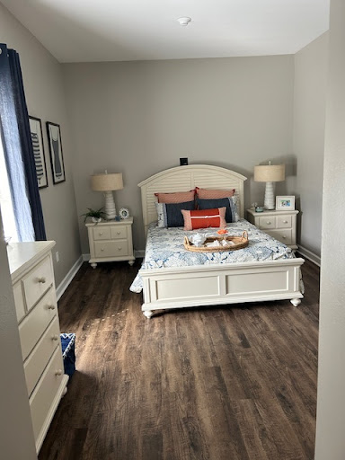 A cozy and well-decorated bedroom featuring a comfortable bed, stylish nightstands, and warm lighting.