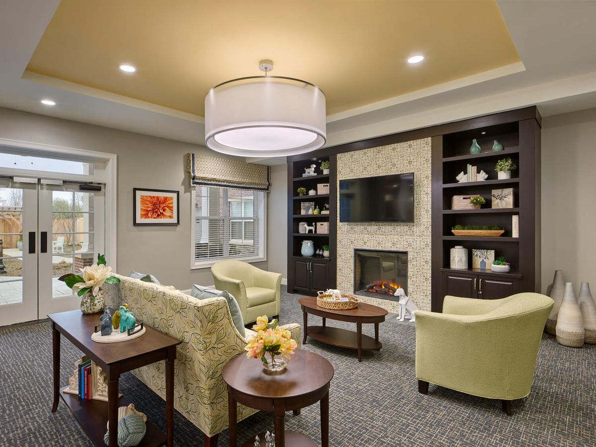 A modern living room with comfortable seating, a fireplace, and built-in shelves.