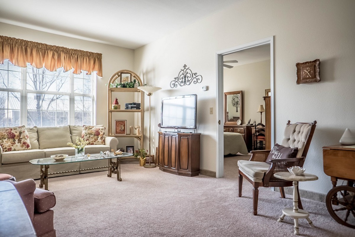 A cozy living room with a television, a comfortable sofa, and well-arranged decorations.