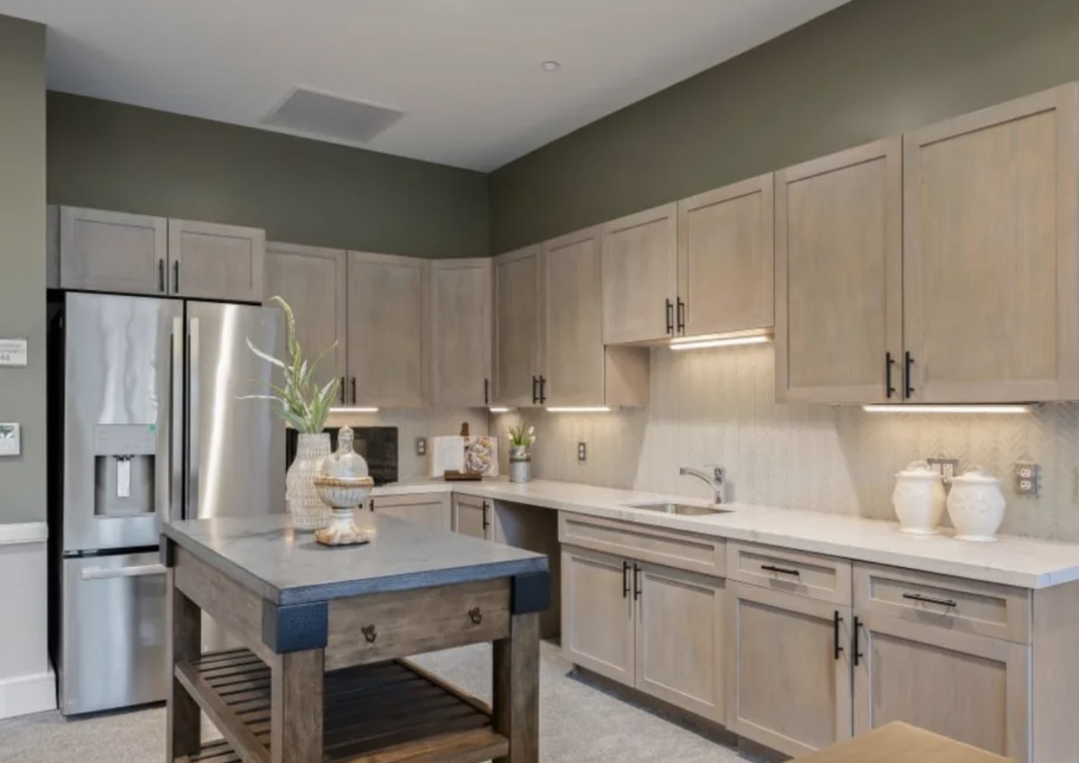 A modern kitchen with wooden cabinets and a central island.