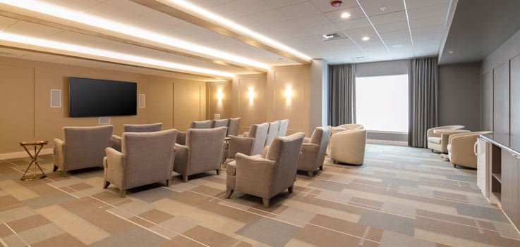A modern waiting room with plush seating and ambient lighting.
